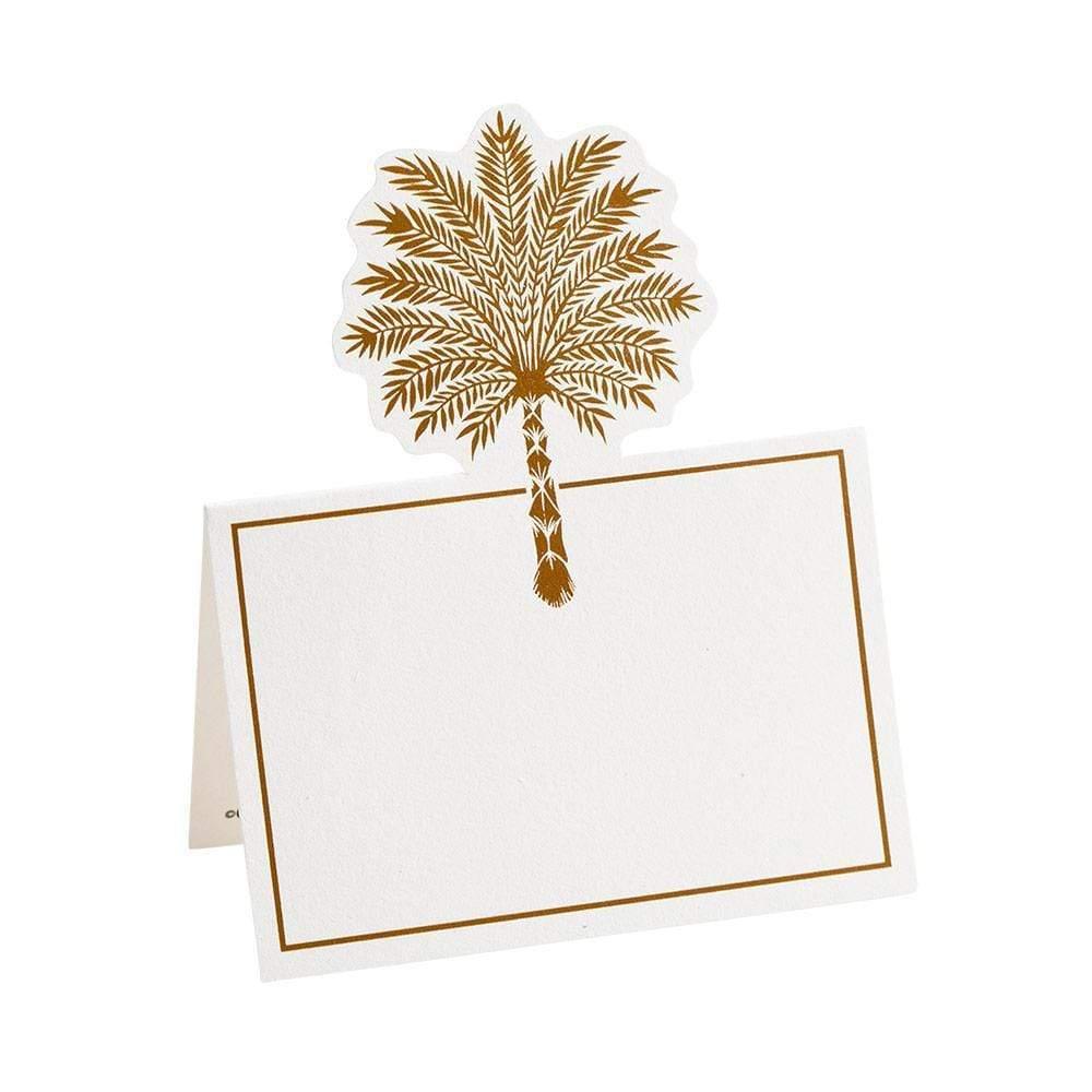 A gold palm tree design on a white place card for a dinner table.