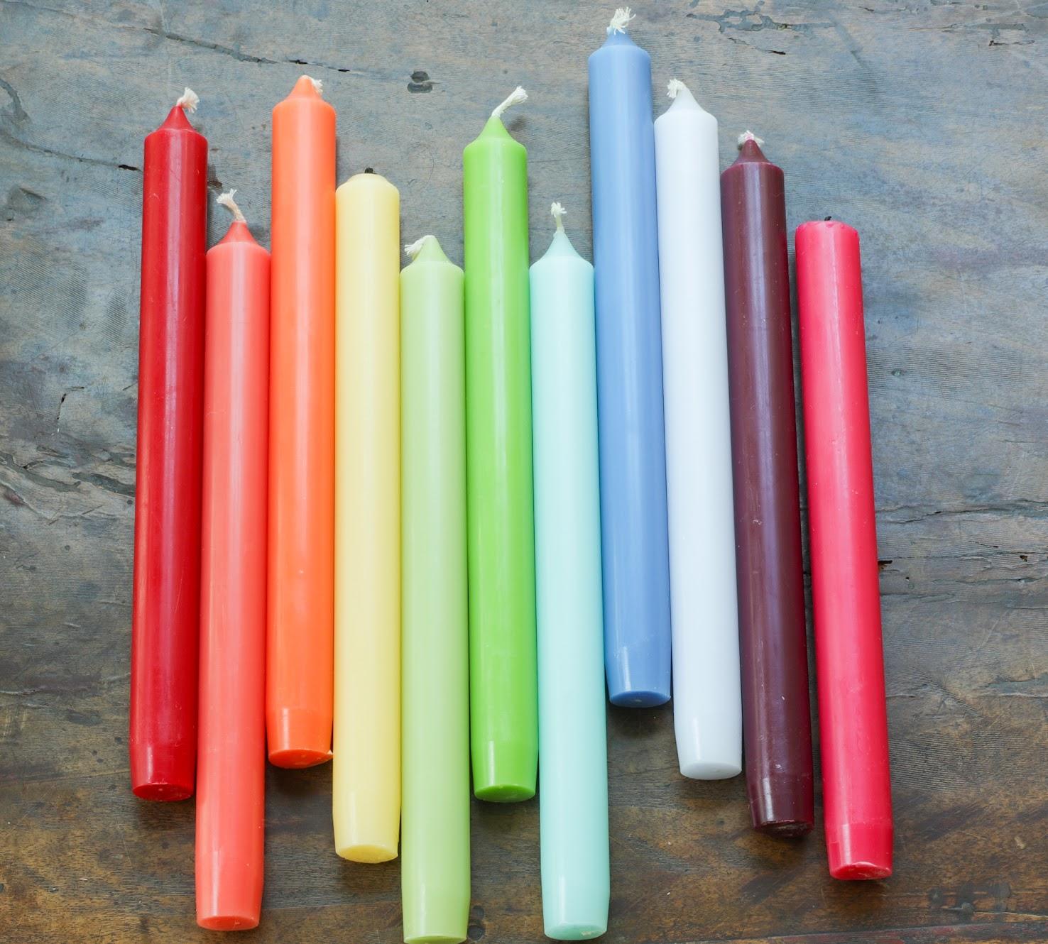 A colorful collection of long candles for parties and events.