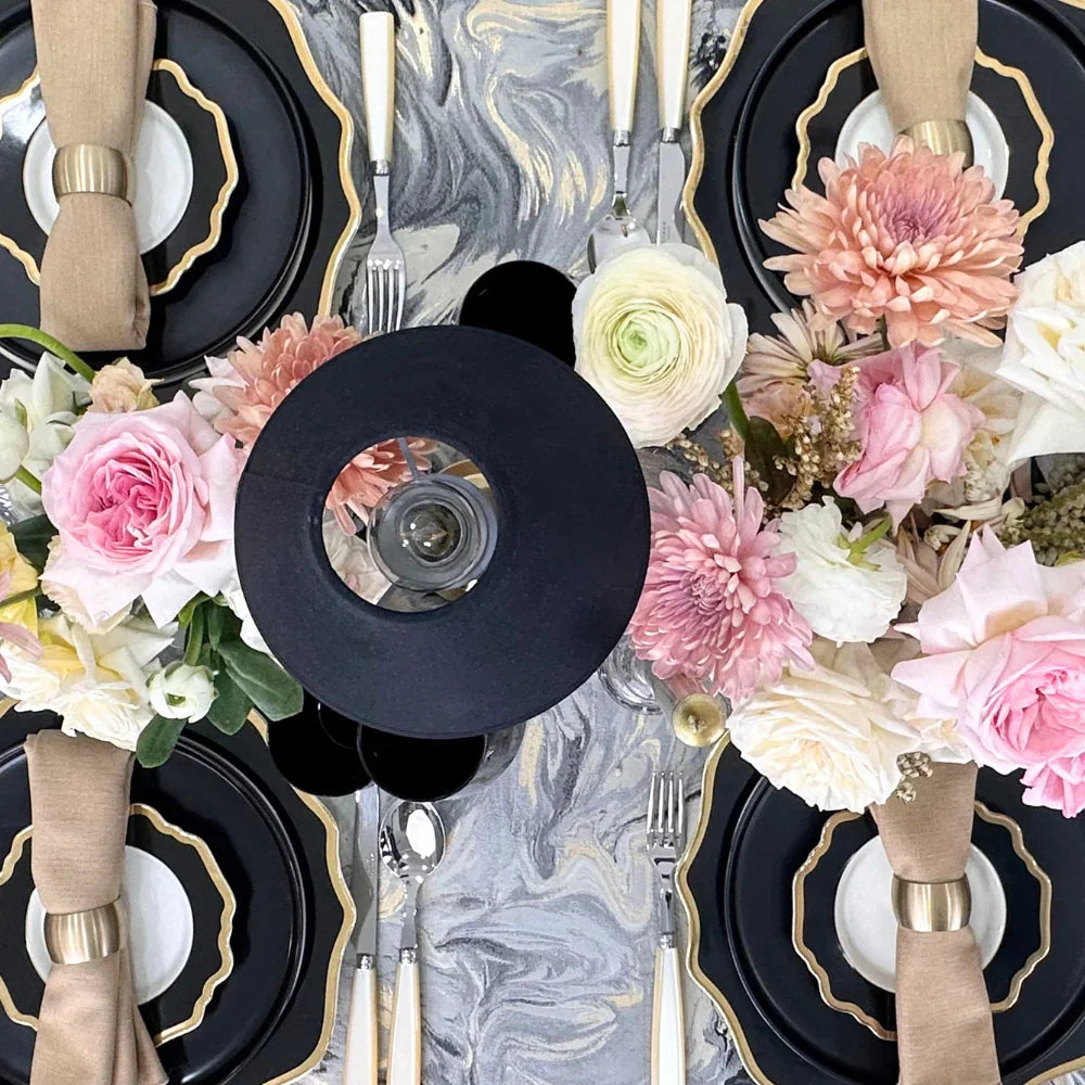 Opulent Twilight-Dining Setup featuring a table set for eight with plates, cutlery, glasses, black chairs, wireless lamps, candle holders, and flower centerpieces.