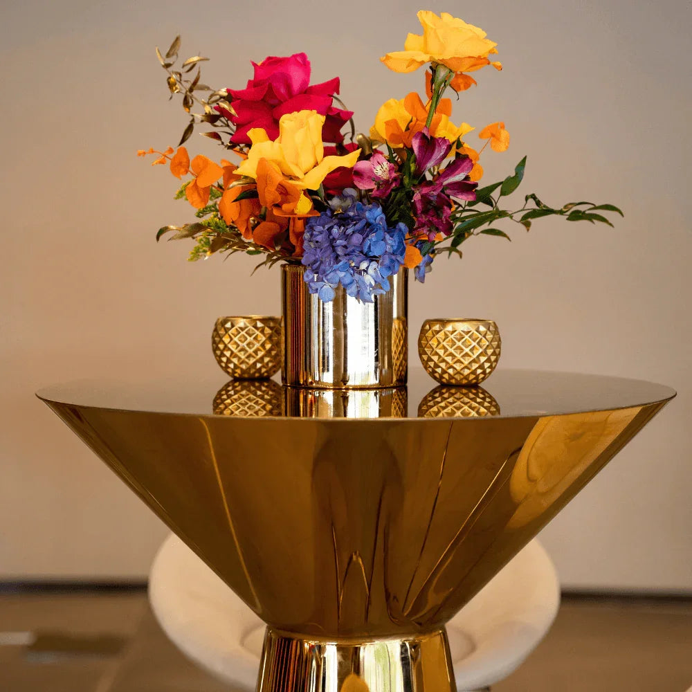 Golden Glam- Cocktail Setup featuring a gold vase flower centerpiece on a table, part of an elegant dining set for eight guests.