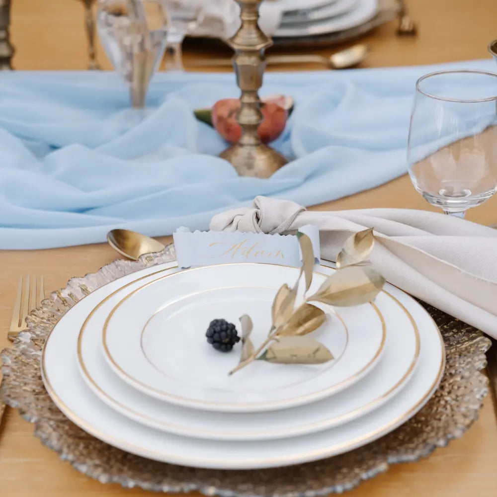 CHARGER PLATE - GOLD LEAF: Elegant gold-edged plate enhancing a formal table setting with porcelain dishes, gold flatware, and decorative accents for lavish events.