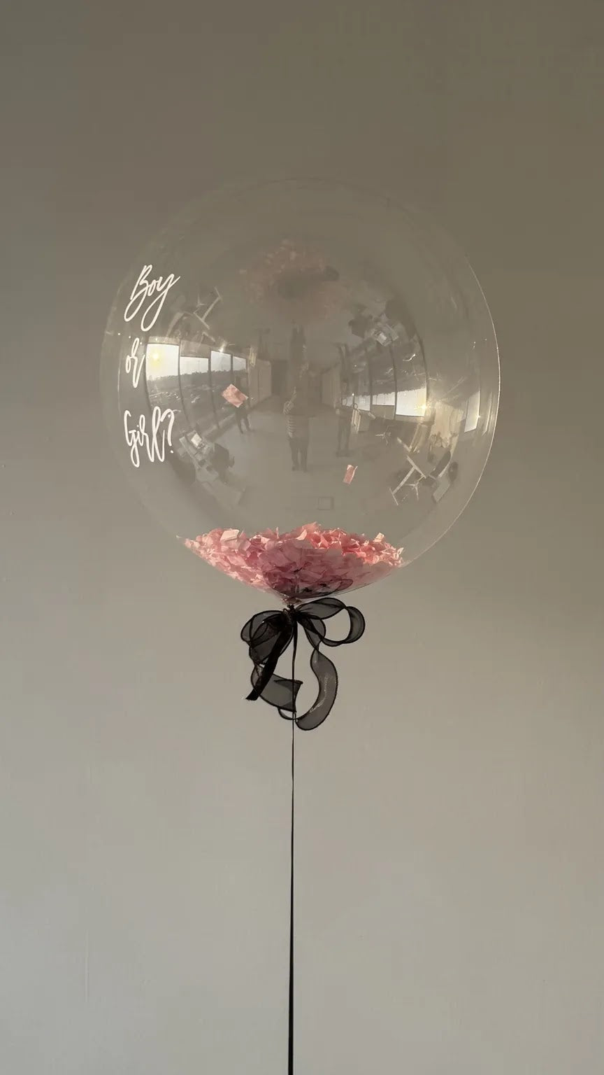 The Big Reveal Balloon after the pop with pink confetti contained inside - no-mess gender reveal Dubai