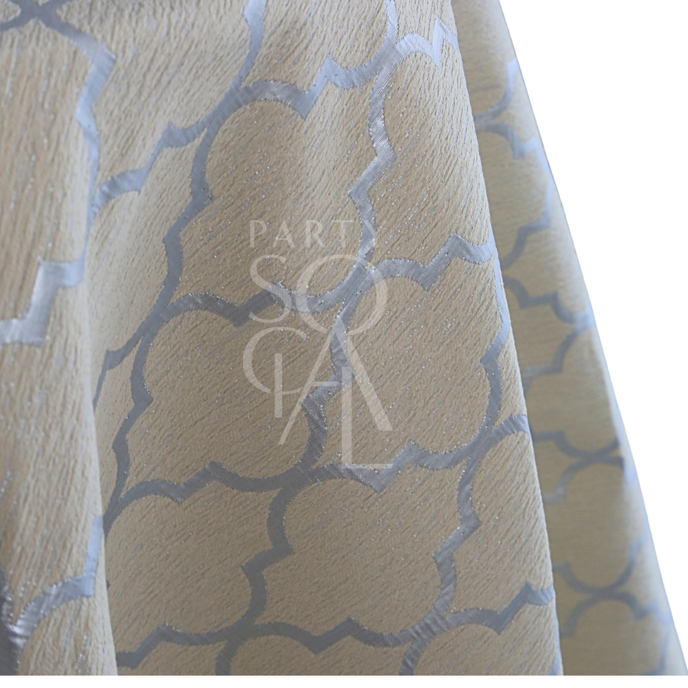 IVORY AND SILVER TRELLIS TABLE CLOTH featuring a pale beige fabric with a silvery metallic quatrefoil pattern, ideal for elegant events and celebrations.