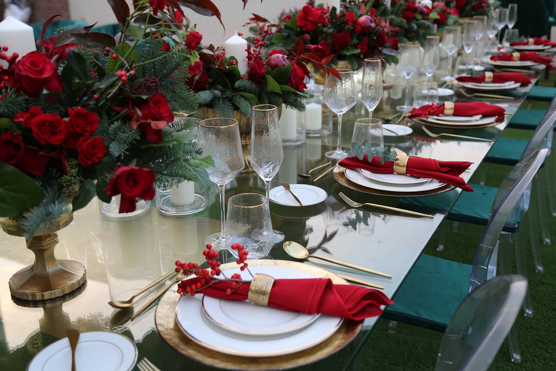 GOLD RIMMED GEOMETRIC GLASSES set on a table with red flowers and dishware, ideal for enhancing premium event settings with elegance.