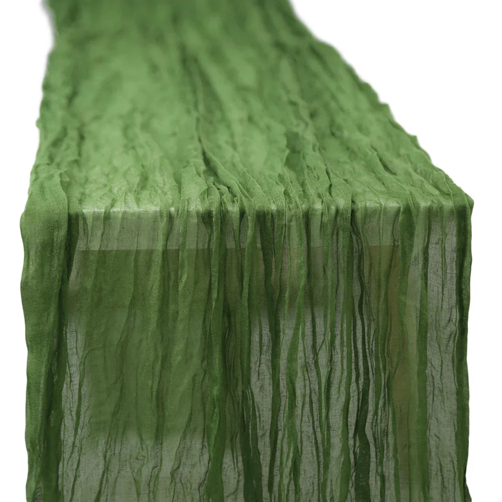 GAUZE TABLE RUNNERS: Close-up of a green gauze table runner, showcasing its premium creased texture, ideal for enhancing elegant dining setups at special occasions.