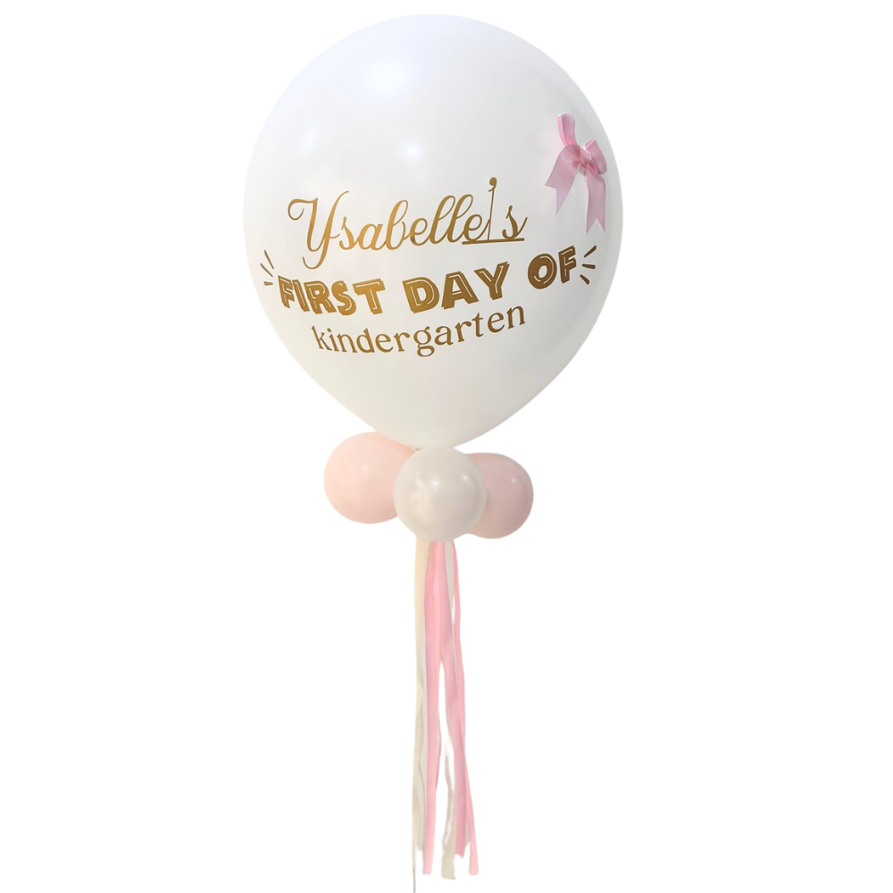 Personalized First Day of School Balloon Wand featuring a large white balloon with gold text, pink ribbon bow, smaller balloons, and streamers, perfect for memorable kindergarten photos.