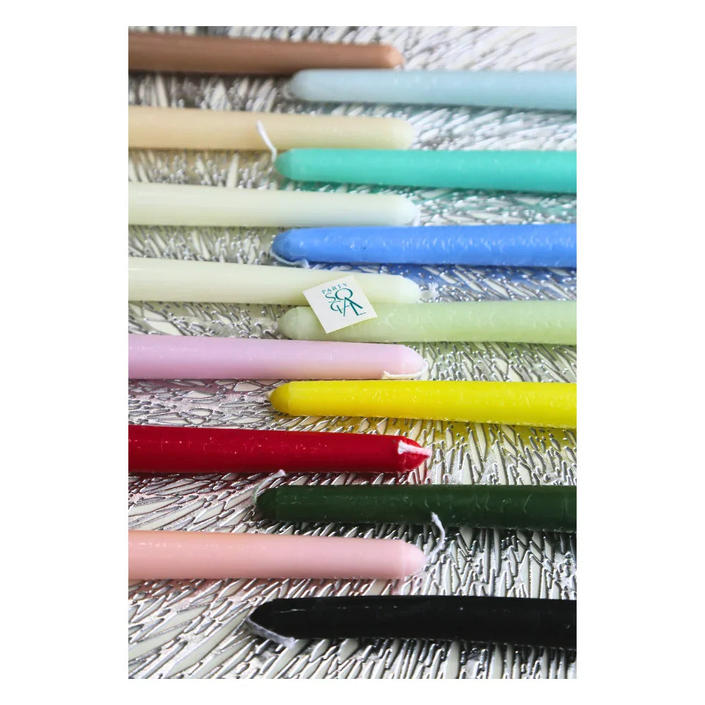 The Tapered Flame Smokeless Candles displayed on a silver surface with a PARTY. tag, showcasing their elegant, dripless design, perfect for adding ambience to events.