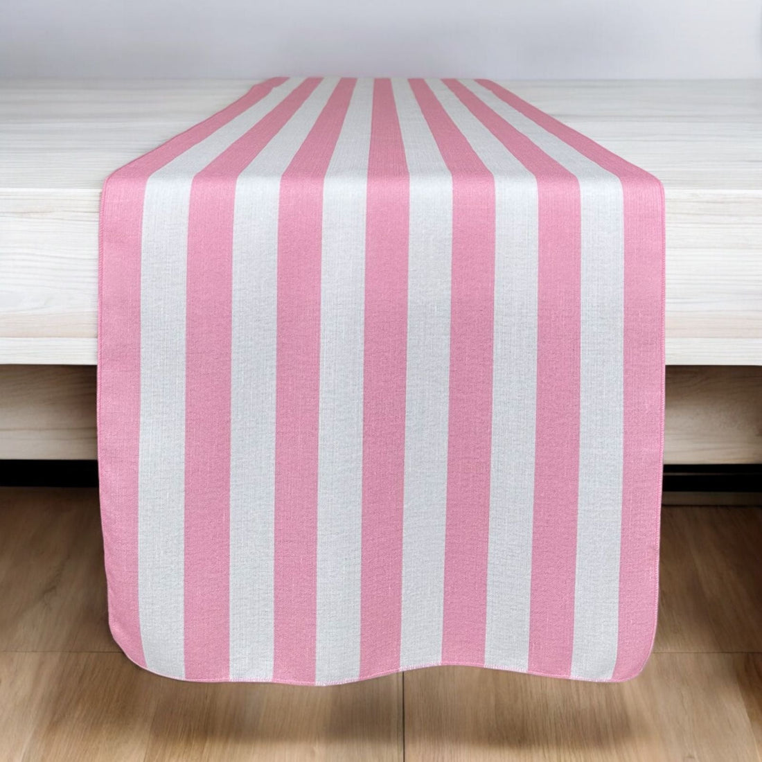 Pink Stripes Table Runner with alternating pink and white stripes, perfect for adding elegance to event tabletops from Party Social.