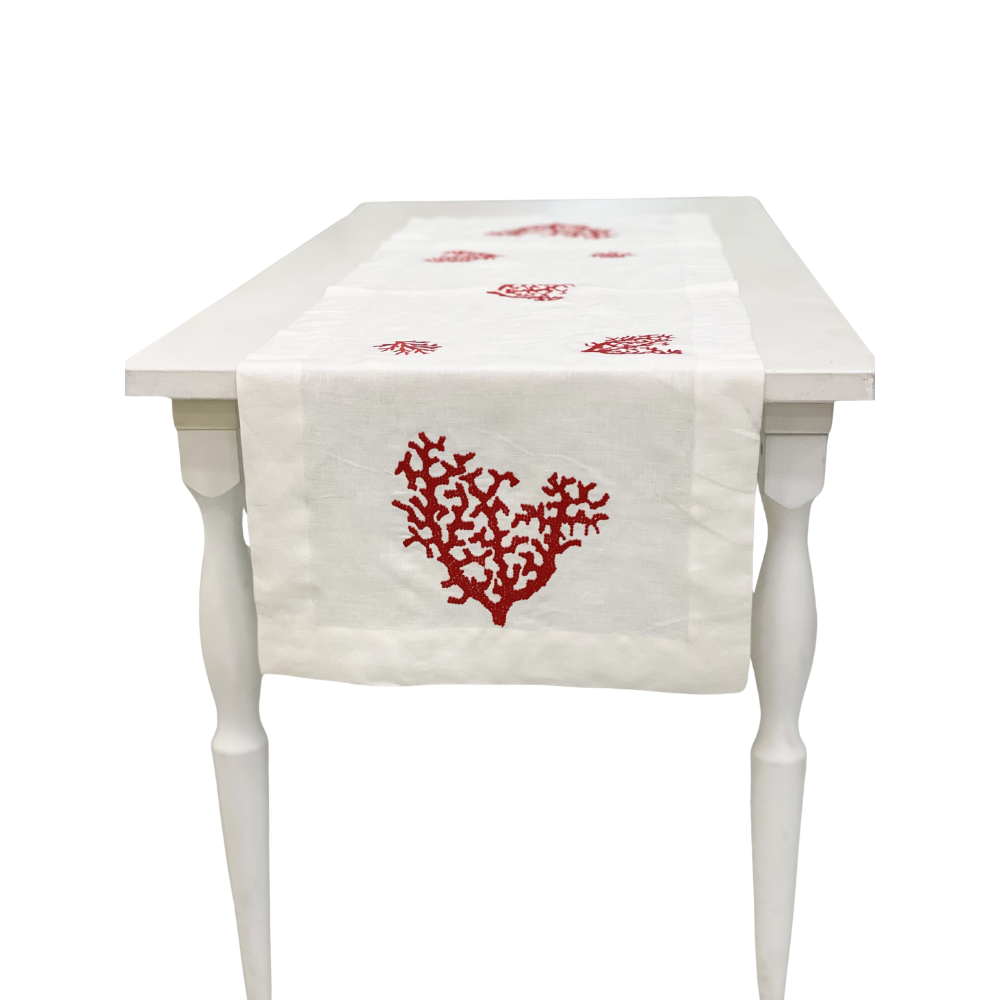 Red Coral Pure Linen Runner displayed on a white wooden table, featuring ivory-white linen with red coral motifs, perfect for elegant party or event setups.