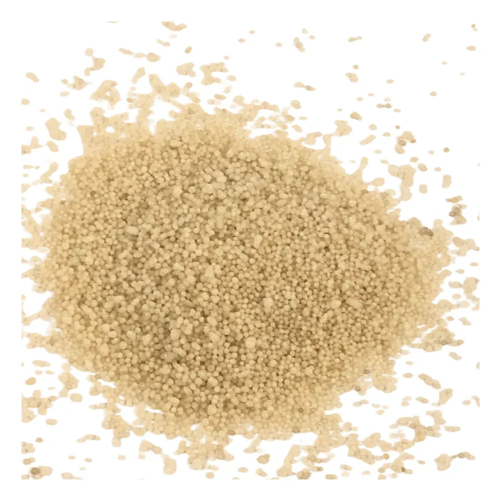 Lumen Sand Wax Candle: A pile of off-white, spherical granules resembling semolina, embodying the serene, artisanal quality of this hand-poured, ambient candle.