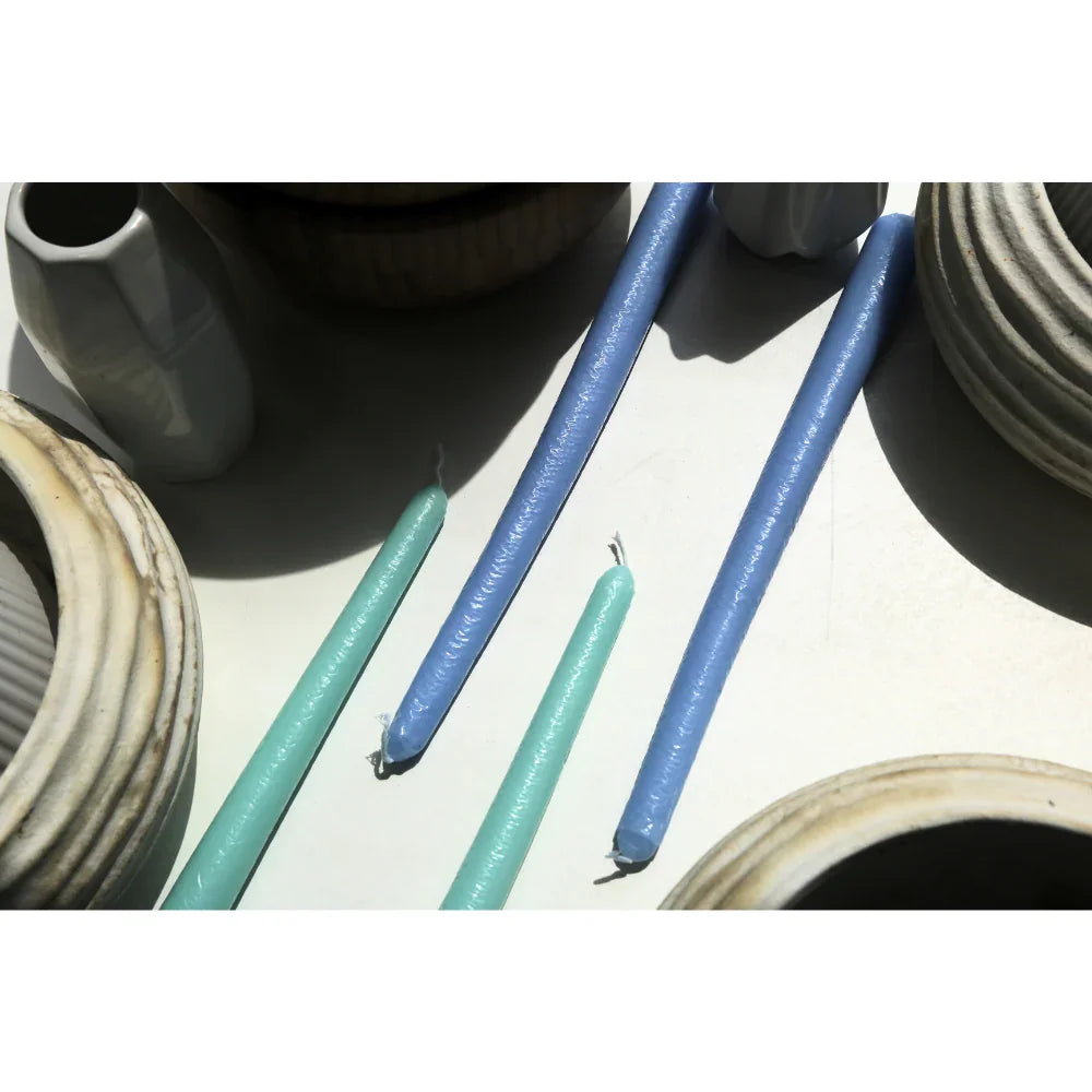 The Tapered Flame Smokeless Candles elegantly arranged with ceramic vessels, showcasing artisan craftsmanship for enhancing warm ambiances at events.