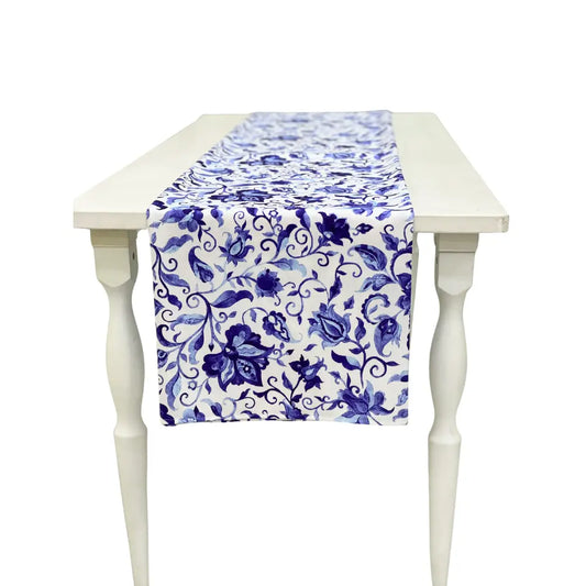 Summer Florals Polyester Linen Runner on a white wooden table, featuring a blue floral pattern, perfect for enhancing special event tablescapes from Party Social.