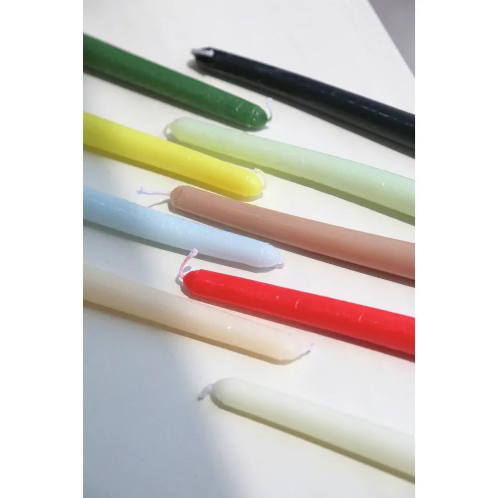 The Tapered Flame Smokeless Candles in various colors, elegantly crafted and unlit, perfect for creating a warm ambience at any event. Sold in sets of 2.