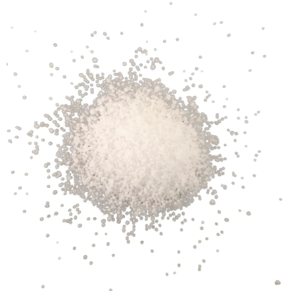 Lumen Sand Wax Candle, a minimalist mound of white, spherical granules, evokes serene ambiance with its artisanal touch, perfect for illuminating special events.