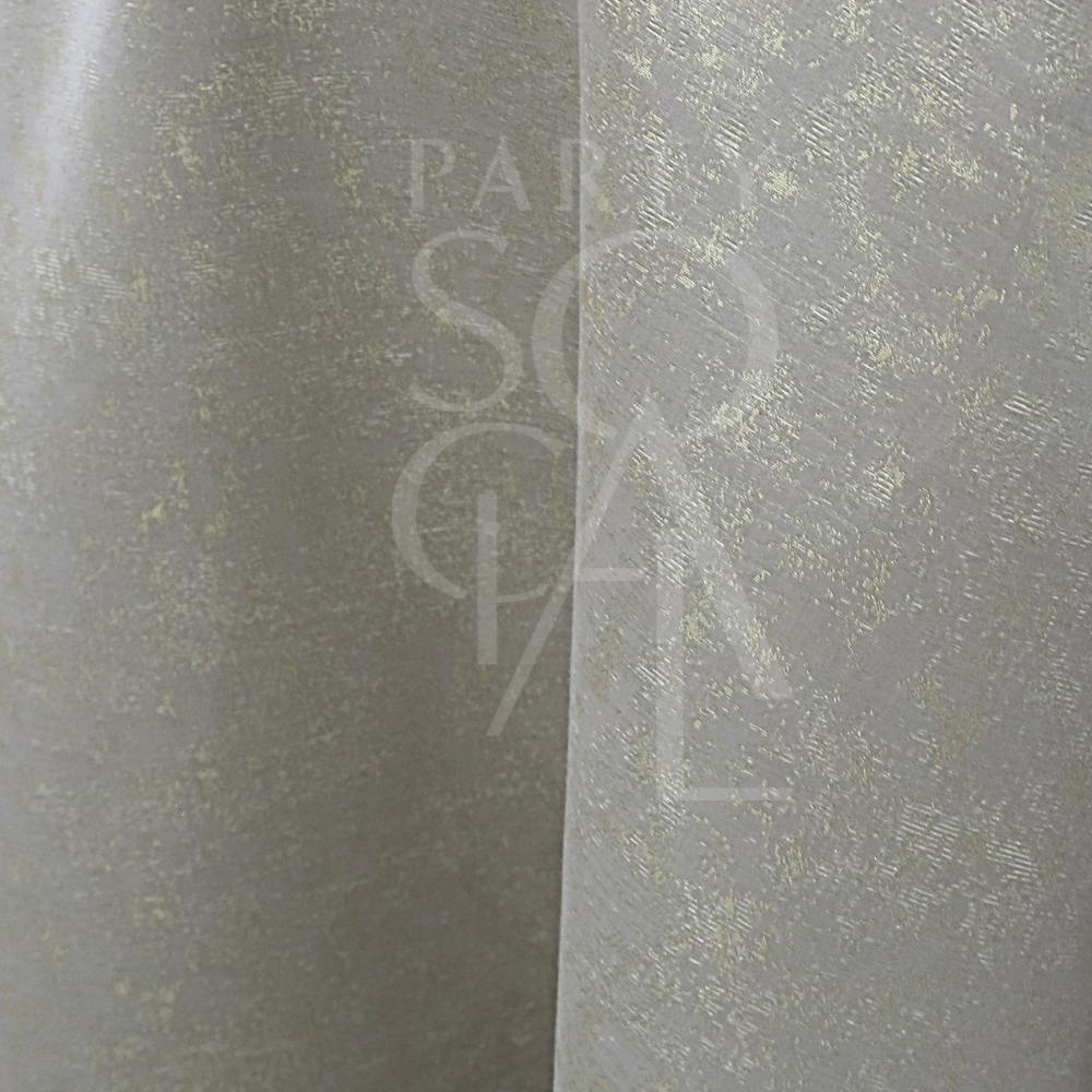 Close-up of GREY IN SHIMMERING GOLD ROUND TABLE CLOTH, featuring a light-grey fabric with a subtle metallic speckled pattern, ideal for elegant event settings.