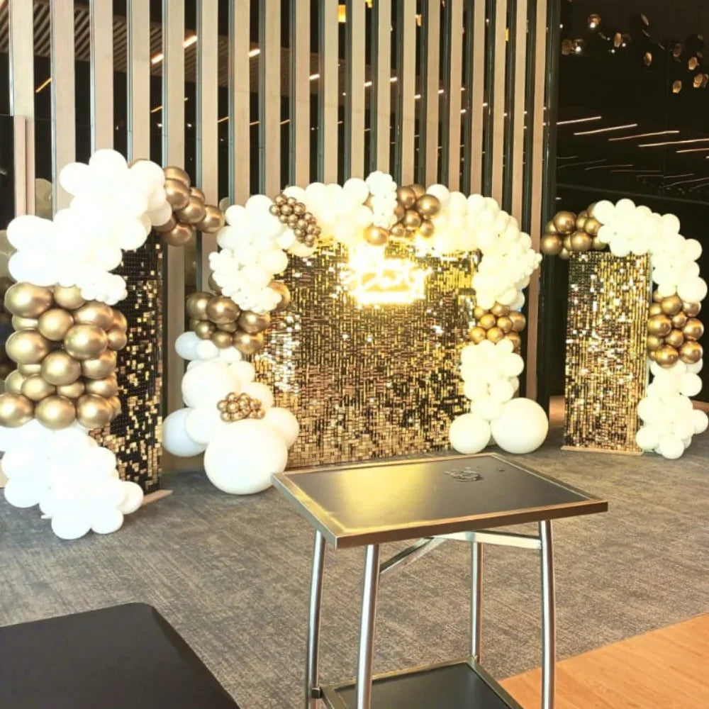 Golden Glam Wall Balloon Backdrop featuring a gold sequin wall with LED neon sign, adorned with white and gold balloons, perfect for elegant events and celebrations.