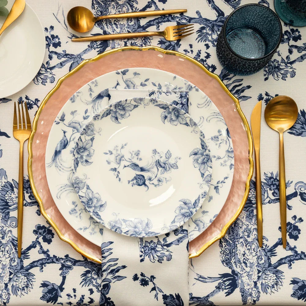This plate features a classic blue and white porcelain-style design with intricate detailing. It is decorated with elegant bird and floral patterns, where graceful birds with flowing tails are perched among delicate branches and blossoms. The artwork is evenly spread across the surface, creating a balanced and sophisticated look.