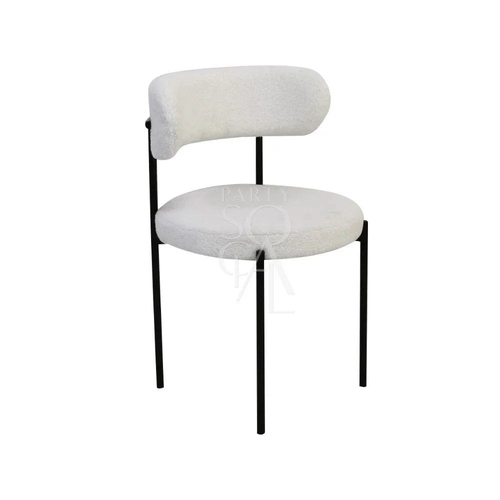 BOUCLE CHAIRS: A modern white chair with sleek black legs, ideal for weddings and corporate events, available at Party Social for rental or purchase.