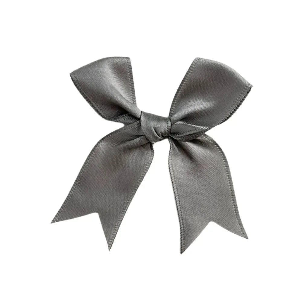 Grey Bow: A close-up of a grey ribbon tied in an elegant bow, ideal for event decoration or gift wrapping, available from Party Social.