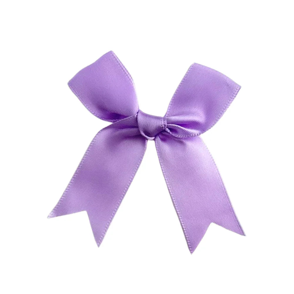 Lilac Bow, a decorative purple ribbon with a bow, perfect for enhancing party decor, available from Party Social for event embellishments.