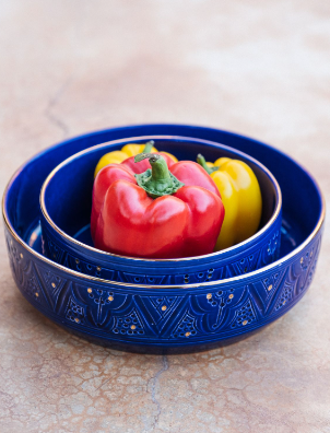 Marrakesh Engraved Ceramic Salad Bowl filled with fresh peppers in a stylish setting.