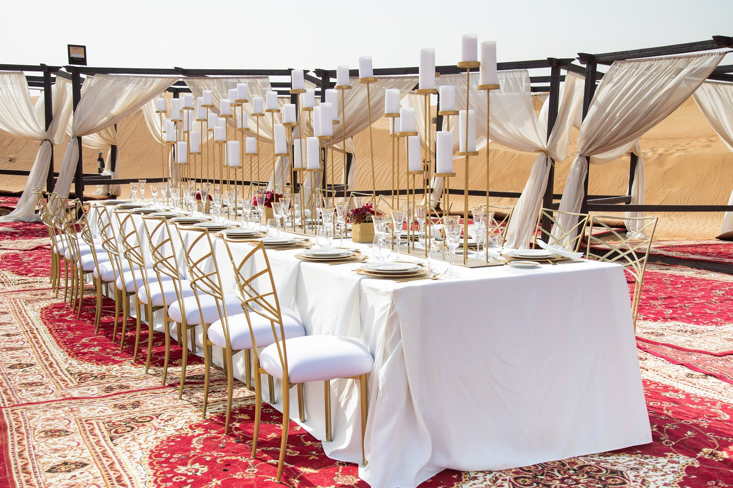 CHAMELEON DINING CHAIR: Elegant gold ballroom chair on a decorated table with plates and candles, ideal for weddings and formal events.