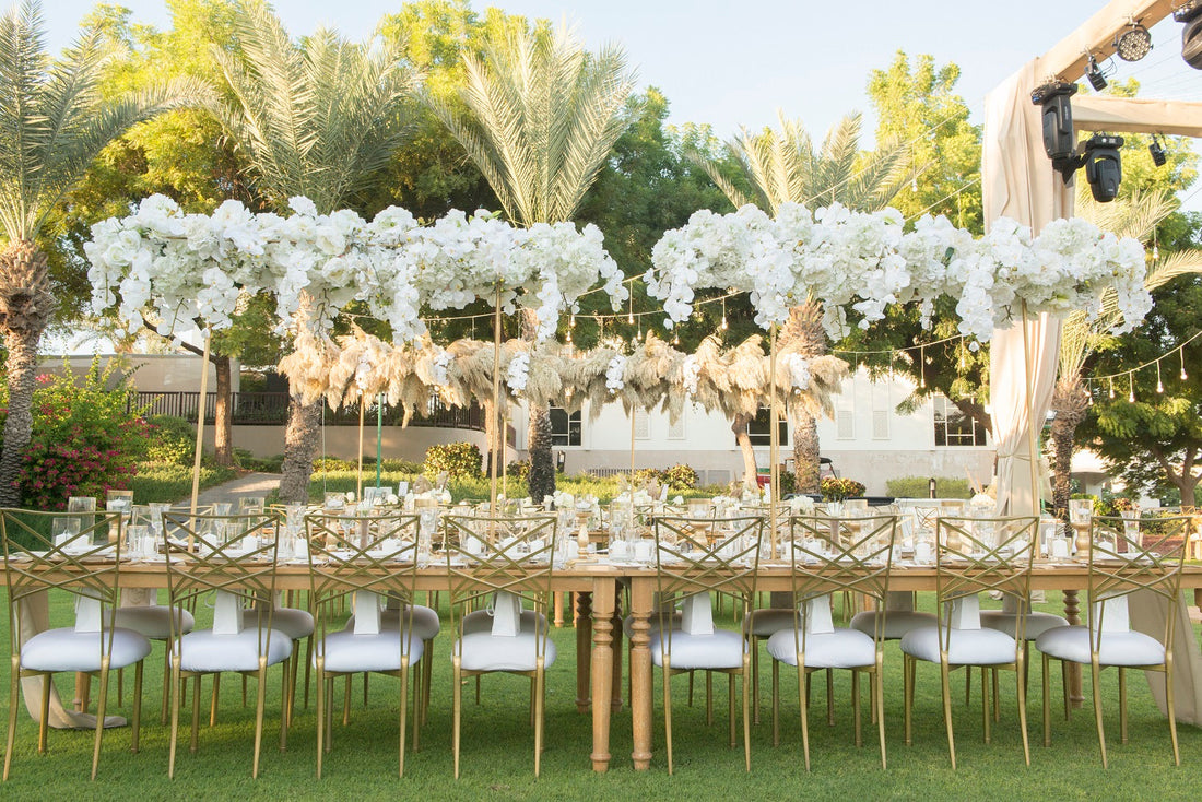 Chameleon Dining Chair with gold legs set for an elegant outdoor event, ideal for weddings and formal gatherings, available at Party Social.