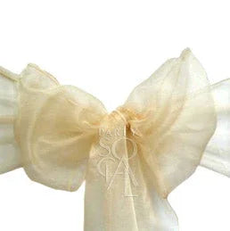 CHAIR SASH ORGANZA: A close-up of a sparkling champagne organza chair sash, showcasing its elegant bow design, perfect for enhancing event decor.