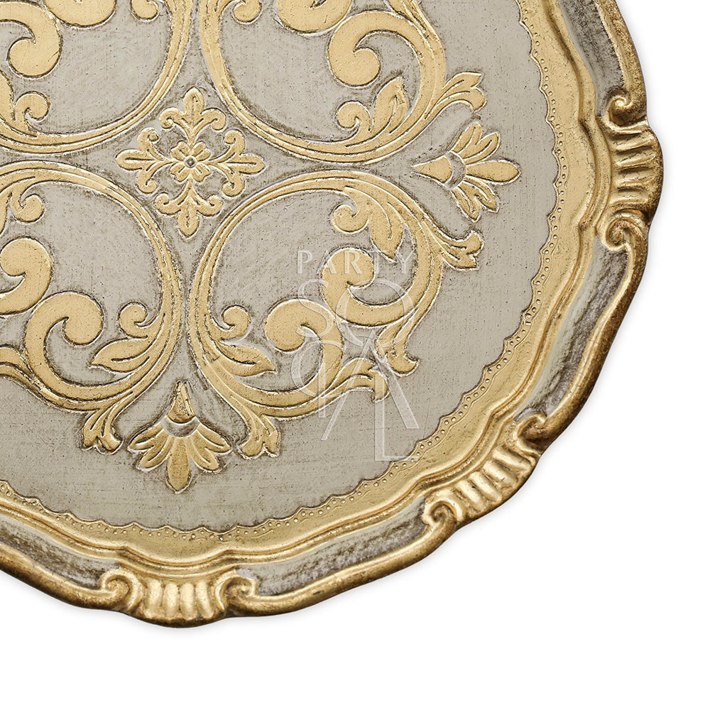 CHARGER PLATE - FLORENTINE ANTIQUE: Close-up of a handcrafted wooden plate with intricate gold and white motifs, ideal for elegant table setups.