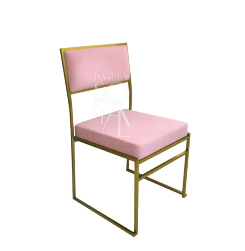 CHARLOTTE CANTILEVER VELVET CHAIR, an elegant pink chair with gold legs, ideal for weddings and corporate events, featuring a sleek, armless design suited for various themes.