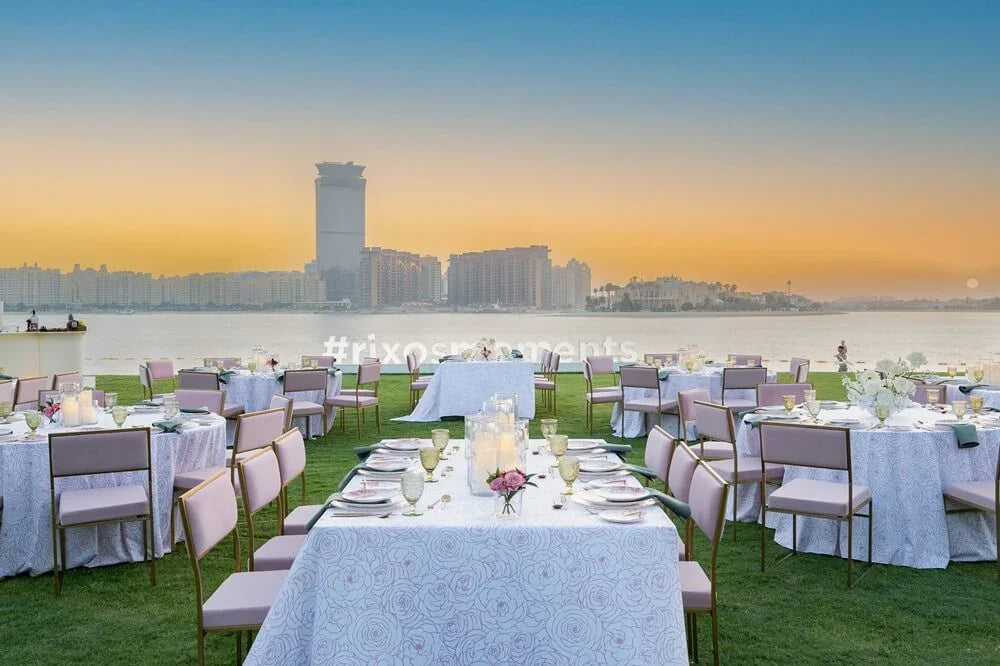 CHARLOTTE CANTILEVER VELVET CHAIR set at an elegantly arranged dinner table, showcasing its suitability for weddings and special events.