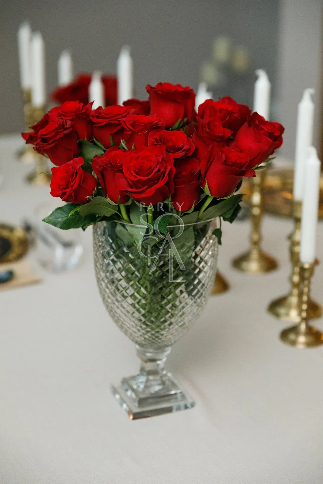 Crystal cut vase with red roses, ideal for elegant table settings. Available in three sizes, perfect for enhancing any party or special occasion decor.
