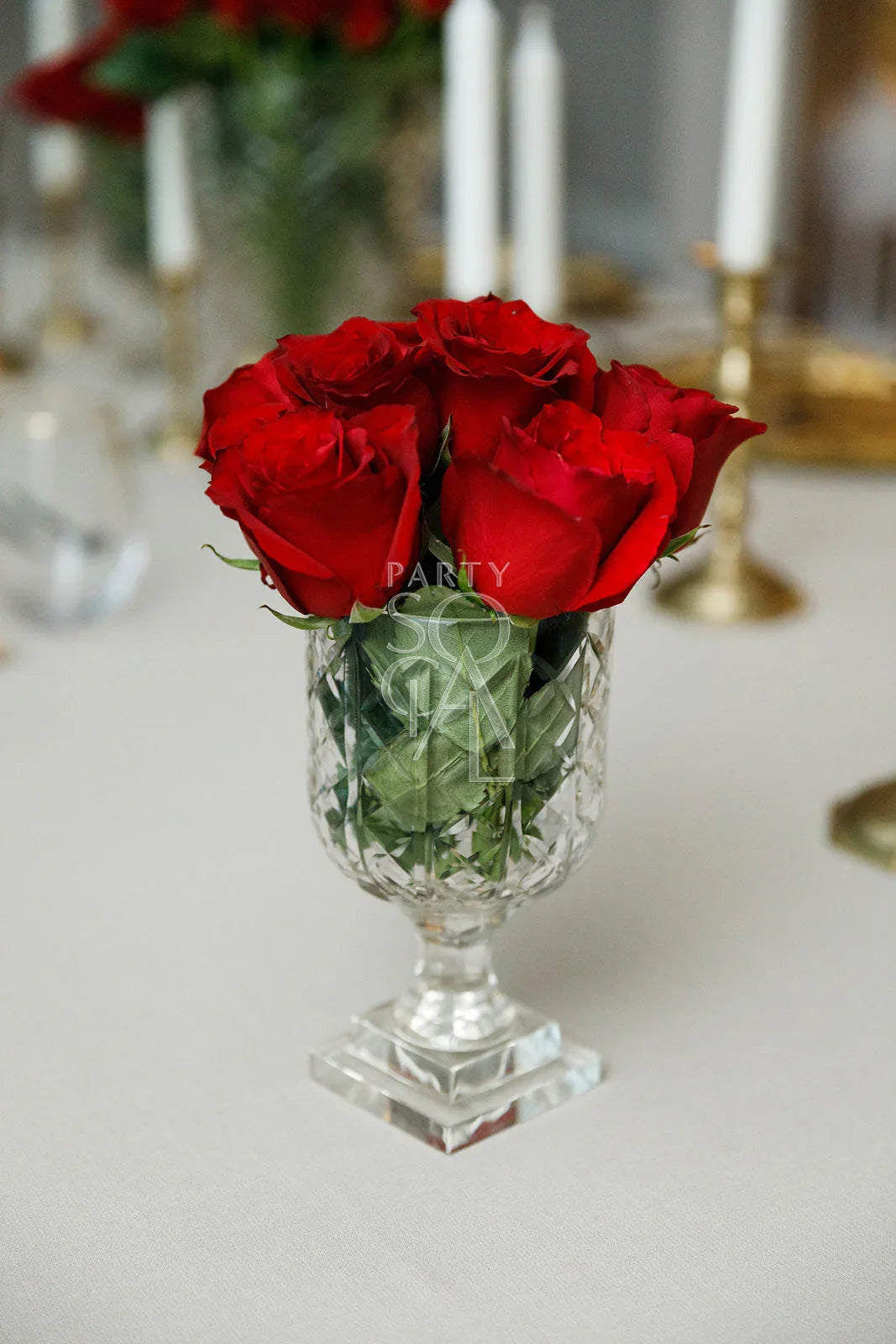 Crystal cut vase featuring red roses, ideal for adding elegance to any table setting at parties or events.