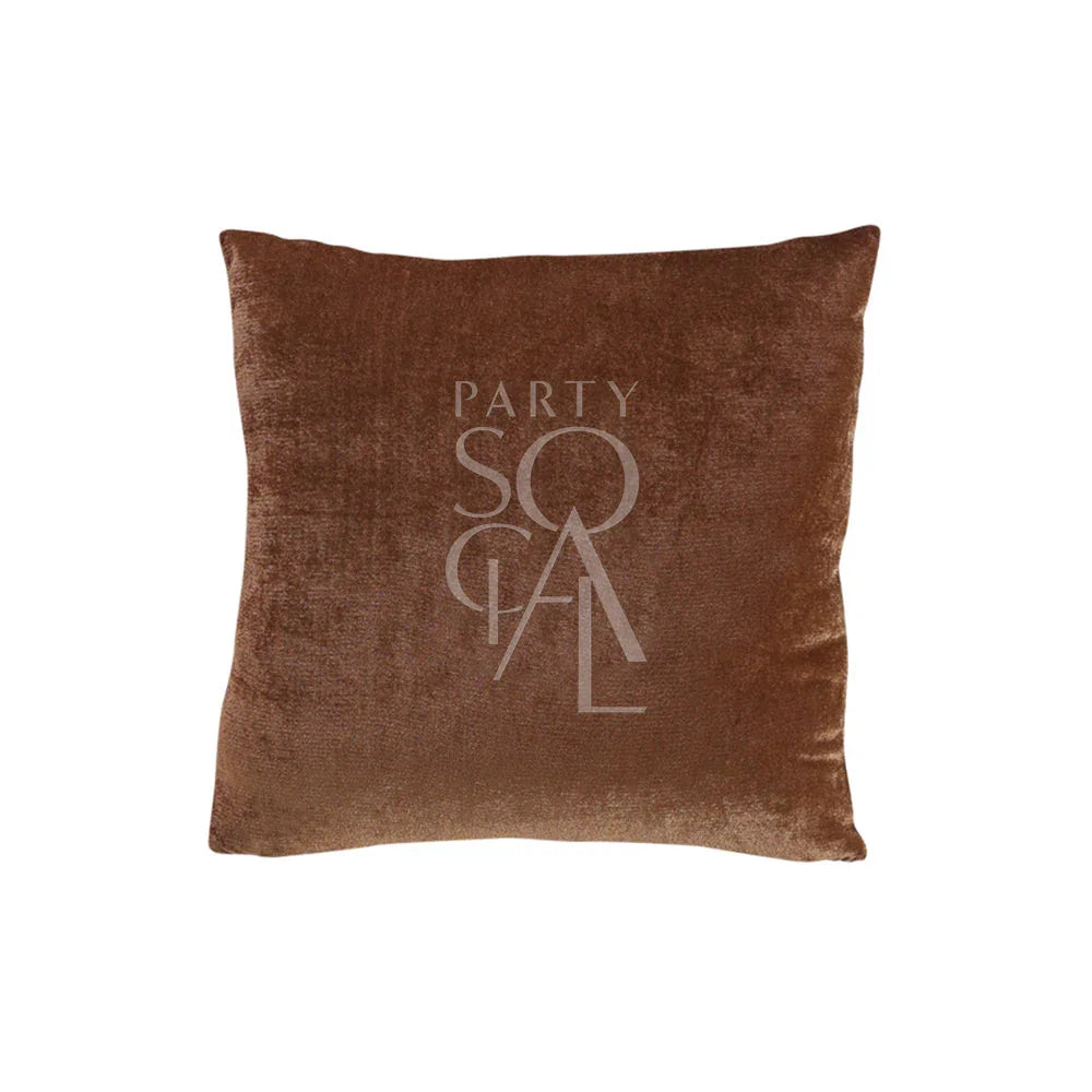 CUSHION COVER VELVET: A plush brown pillow featuring a logo, crafted from premium velvet fabric, ideal for enhancing event decor with a touch of elegance.
