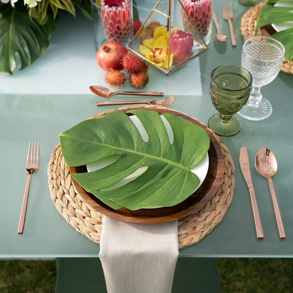 Cutlery Rose Gold set displayed elegantly on a table with a decorative floral arrangement, showcasing its stylish design ideal for enhancing any tablescape.