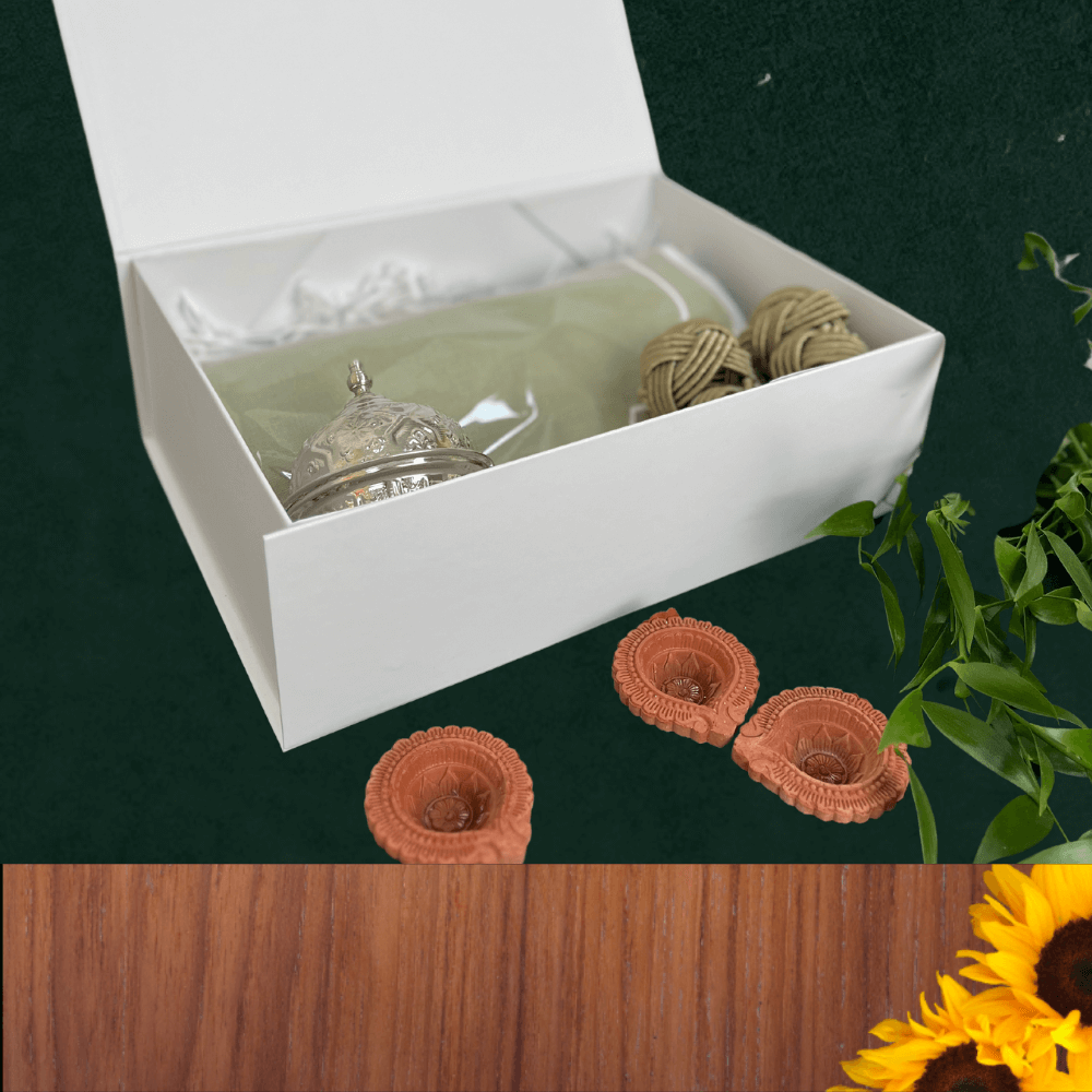 Diwali Gift Box - Large featuring a silver bell and yarn, perfect for festive gifting with elegant Thali Sets included.