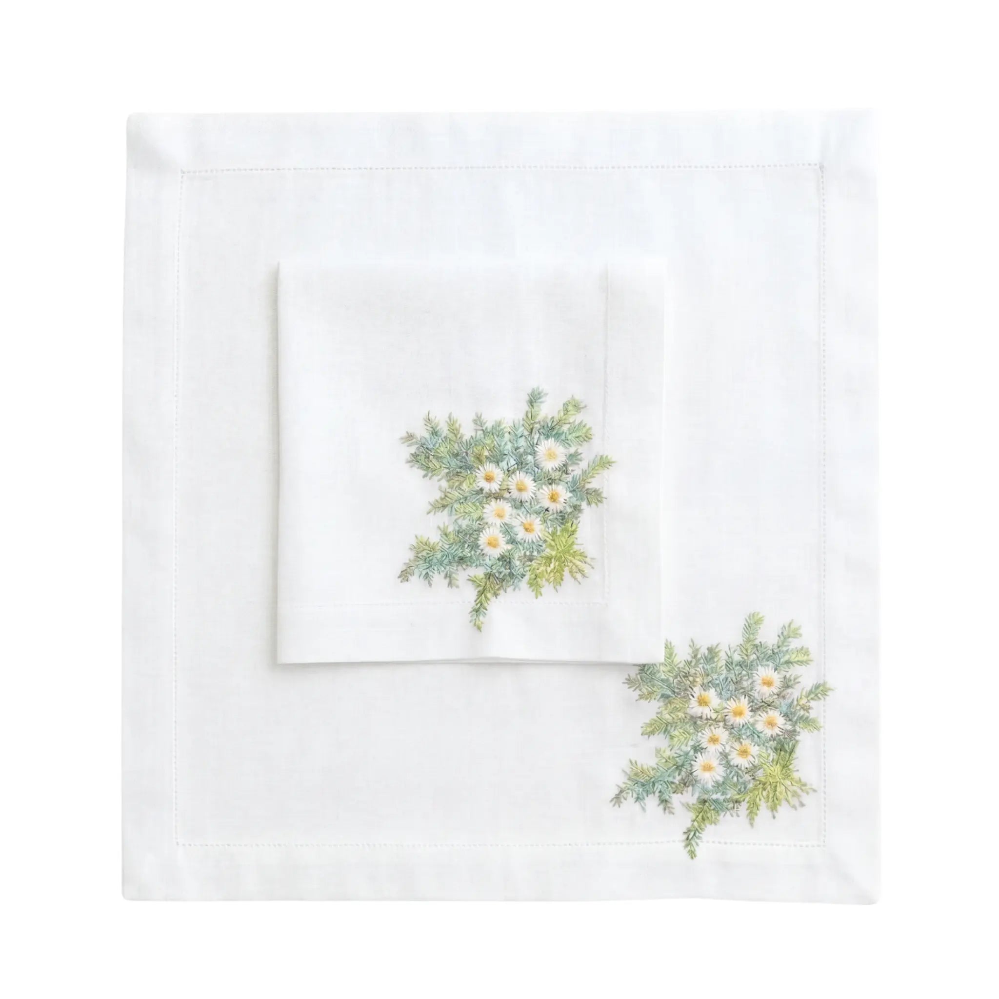 Daisy Pure Linen Dinner Napkin set features two white linen napkins with embroidered daisy sprays, ideal for elegant table settings at special events.