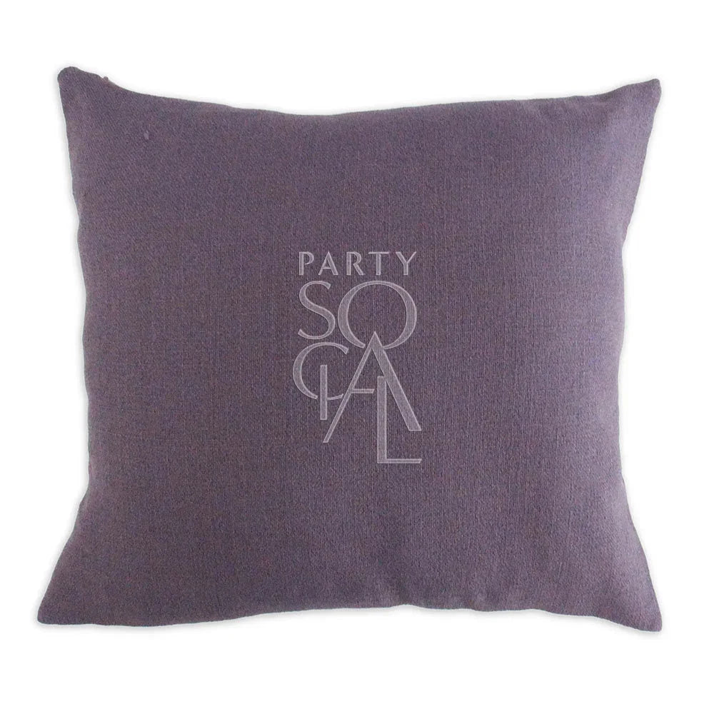 CUSHION COVER LINEN WEAVE: A purple cushion with a logo, crafted from premium linen weave fabric, offering stylish comfort for party and event settings.