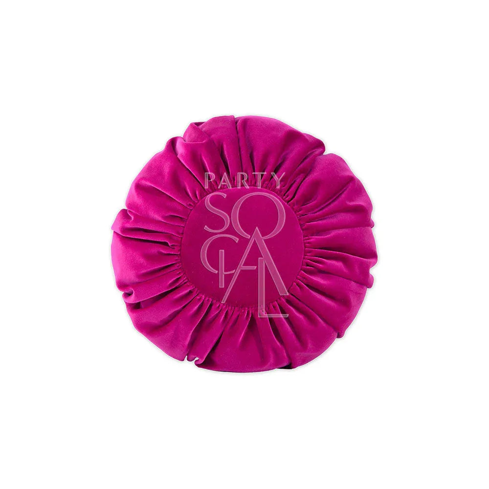 CUSHION COVER ROUND VELVET: A pink pillow with pleated texture and ruffled edges, ideal for adding luxury to any party or event setting.