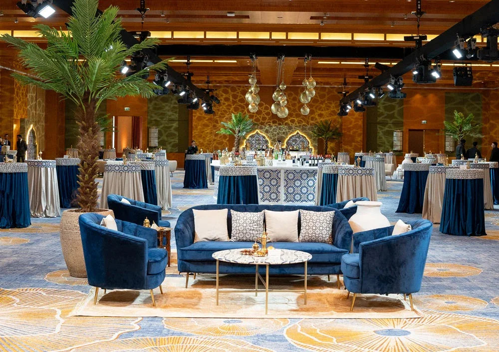 CUSHION GEOMETRIC PRINT velvet cover on a blue couch in an elegantly furnished room, showcasing its premium design suitable for stylish events and gatherings.