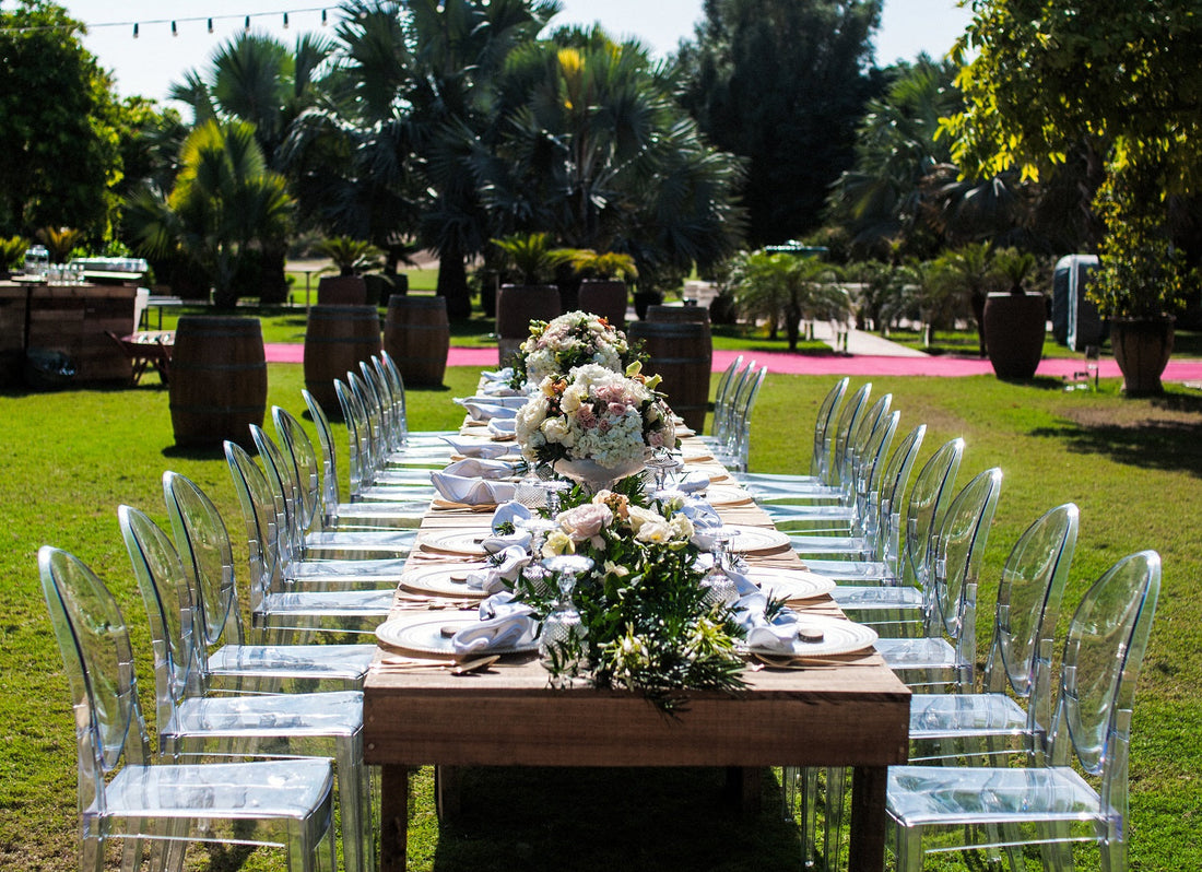 GHOST CHAIR W/O ARMS (VICTORIA) elegantly set at an outdoor party table, showcasing its classic design, perfect for weddings and events.