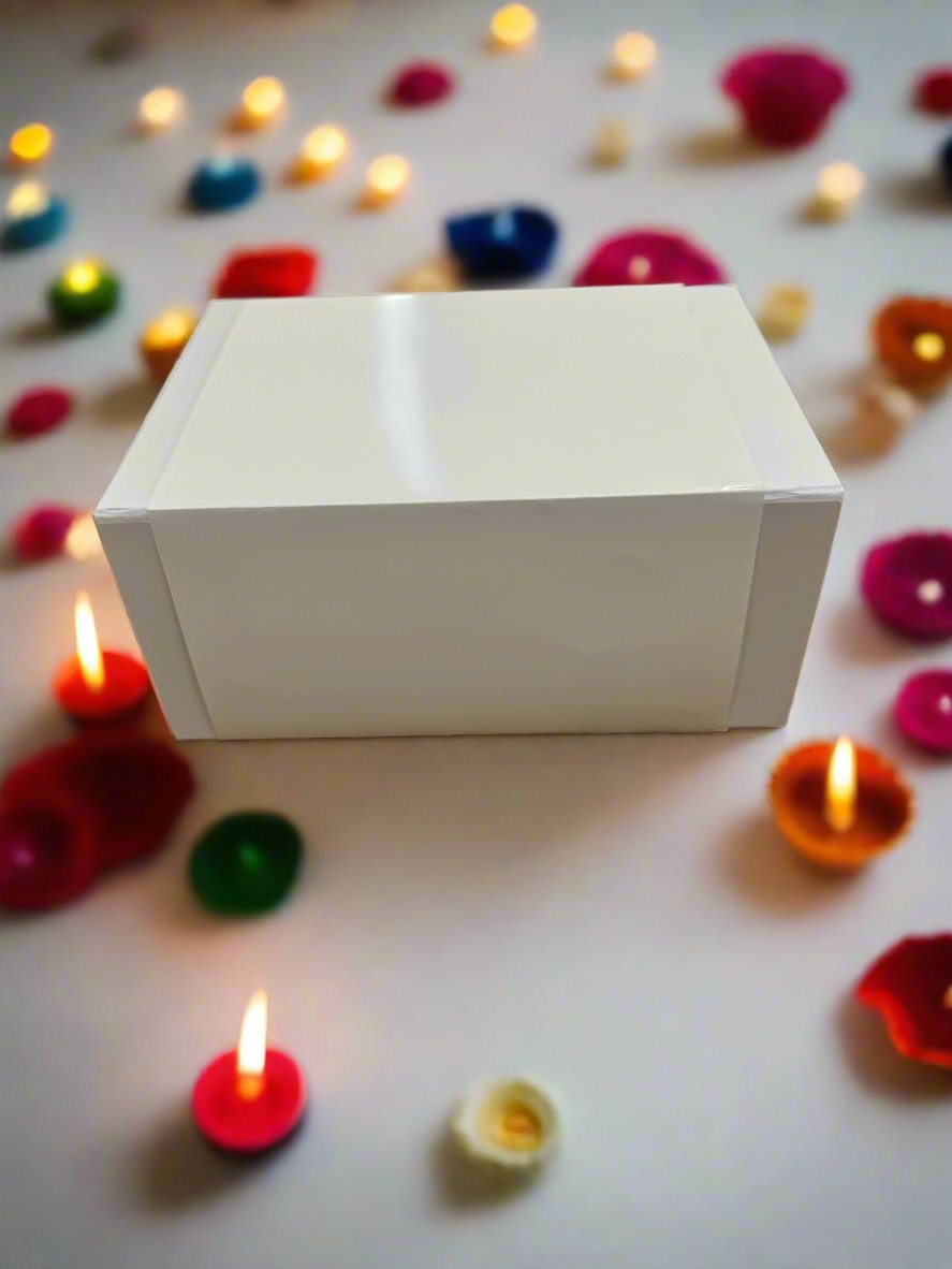 White Gift Box on hardwood surface, offering premium magnetic fold over closure, ideal for elevating the presentation of gifts with coordinating tissue paper and tags.