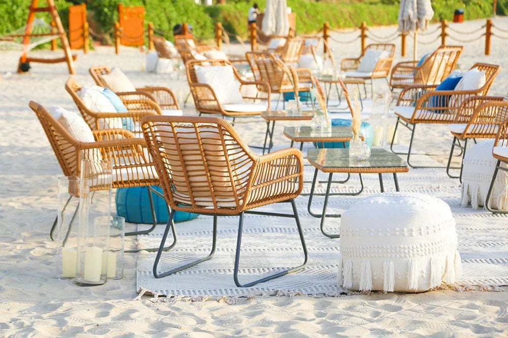 FABRIC & JUTE POUFS on a beach setup, surrounded by chairs and tables, ideal for events as versatile seating or decor.