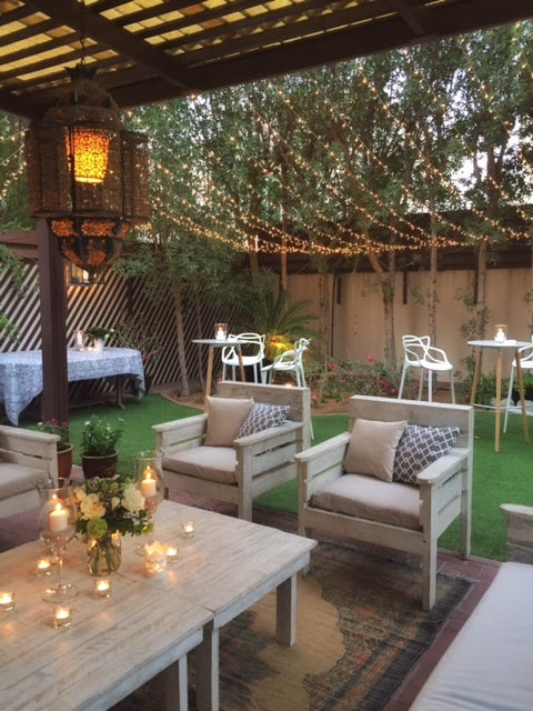 White Wood Armchair displayed on a patio with a bouquet on a table, ideal for beach and lounge settings. Dimension: 73cm L x 75cm W x 87cm H.