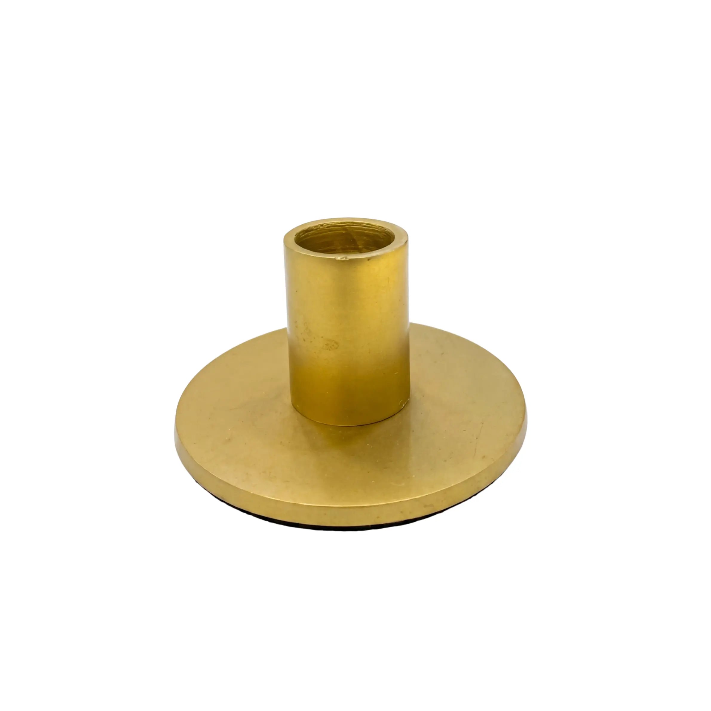 LOW CANDLE HOLDER, a minimal brass piece with a flat base and cylindrical socket, perfect for enhancing rustic or premium event settings.