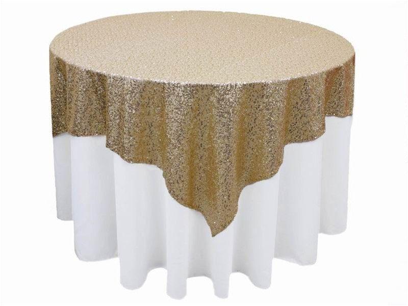 Sequin Overlays: Round table with a luxurious gold and white sequin tablecloth, ideal for enhancing any event setting.