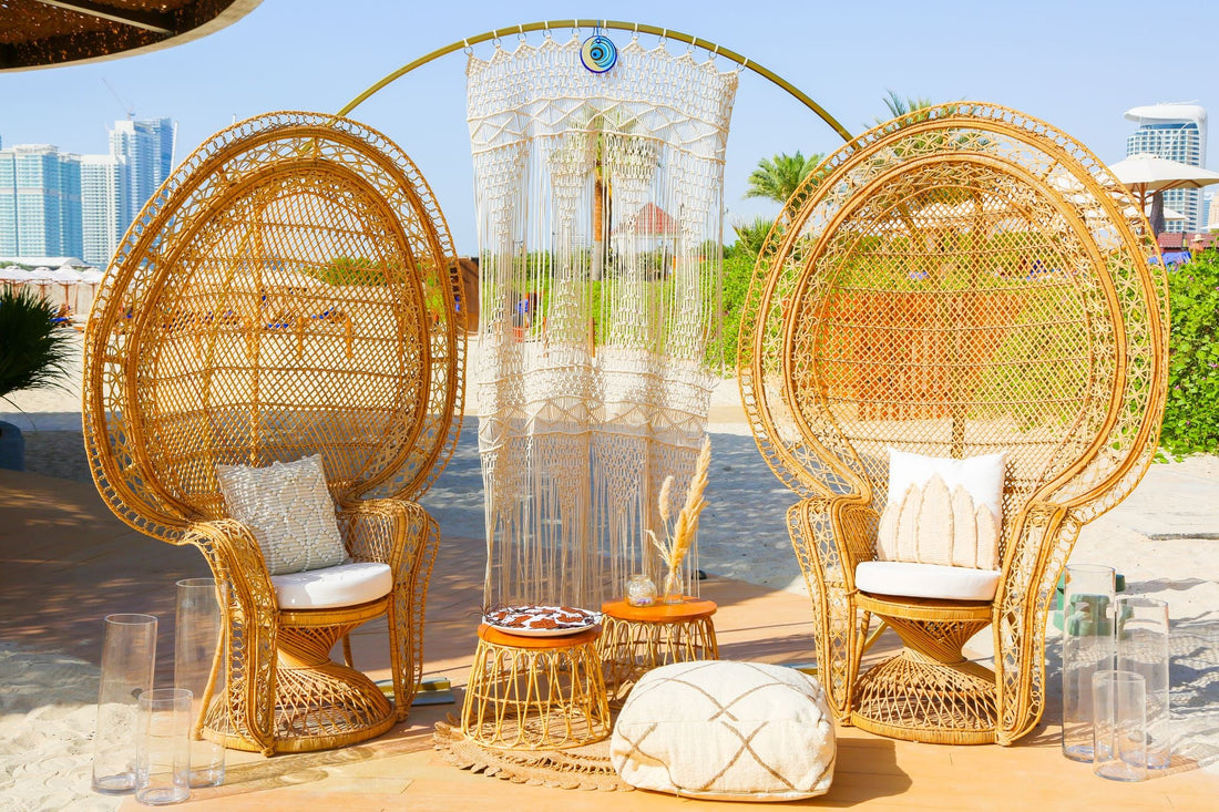 Peacock Chair made of cane, perfect for weddings and outdoor events. Features wicker design with a white pillow for added comfort.