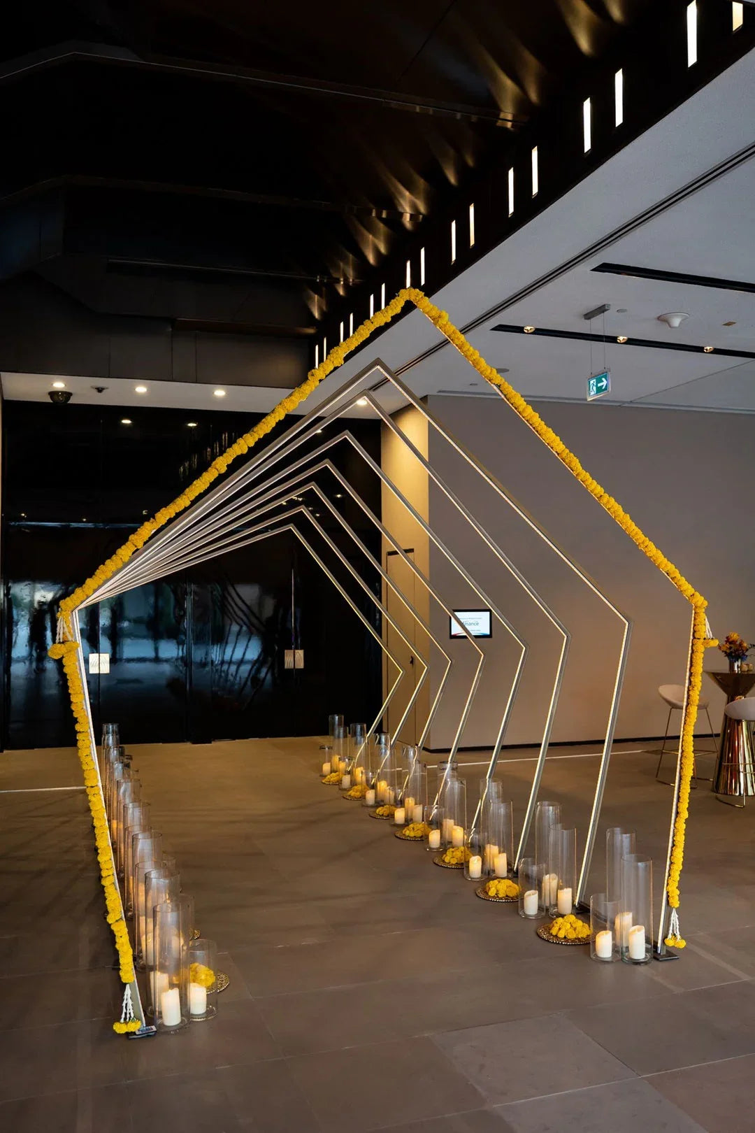 PENTAGON TUNNEL WITH COLOR CHANGING LED displayed in a room, showcasing gold arches with neon rope lighting, ideal for vibrant party entrances.