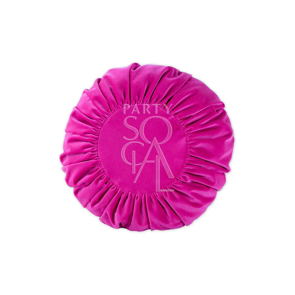 CUSHION COVER ROUND VELVET: A pink, round, pleated velvet cushion with a logo, ideal for adding a bold statement to luxury events.