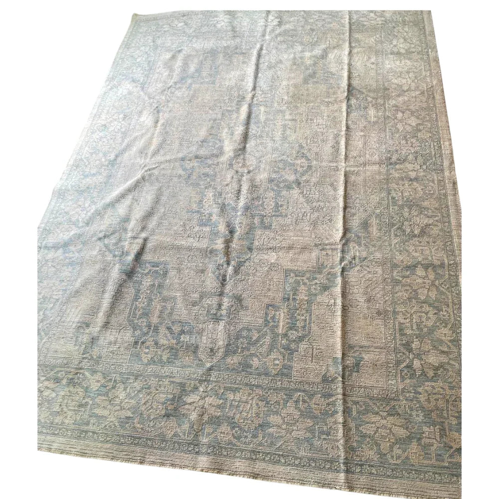 RUG VINTAGE PATTERN: A large rectangular area rug with a faded, vintage medallion and floral motif, ideal for adding elegance to event spaces.